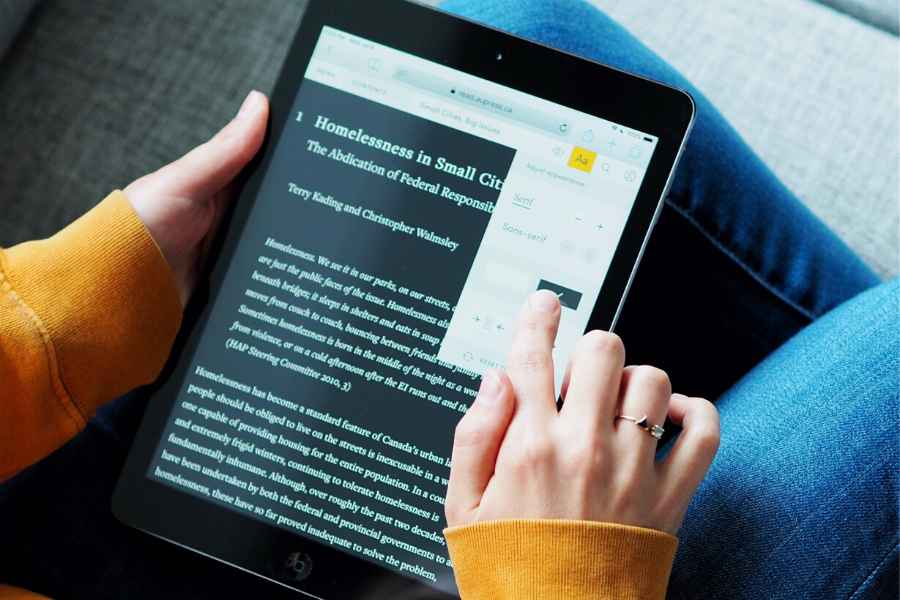 A person annotates their Open Access ebook through Athabasca University Press’s online reader.